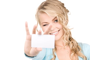 woman holding white card with white background