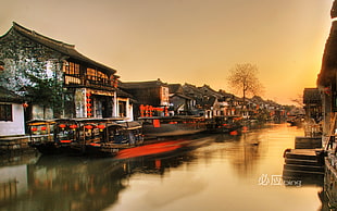 time-lapsed photo of street, boat, river