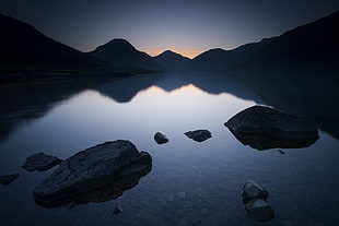 rocks on body of water under blue sky, wast water