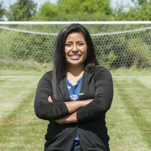 Woman standing infront of soccer goal summer S