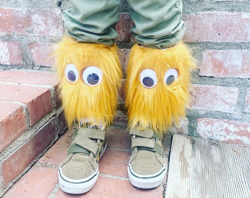 Socks with faux fur and giant googly eyes glued to them to make monster socks for Crazy Sock Day