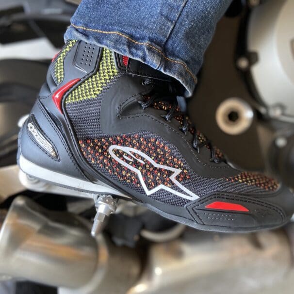 Alpinestars Faster 3 Rideknit shoes sitting on top of brick wall