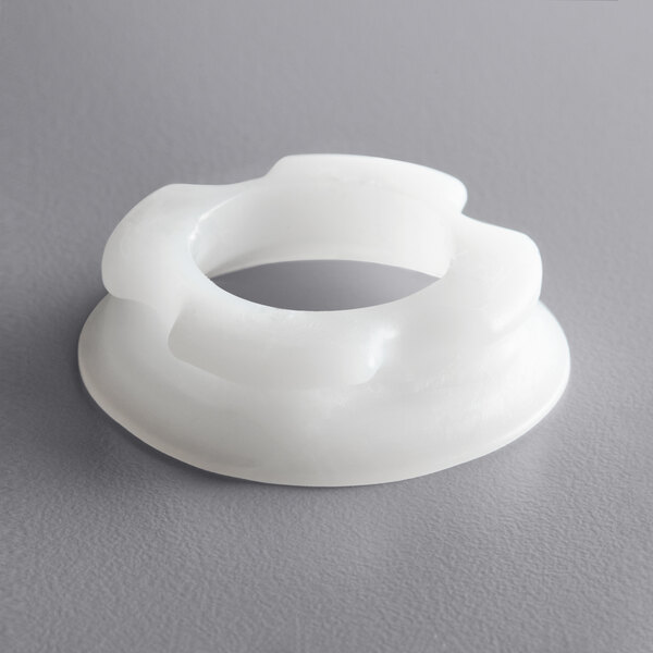 A white plastic Bunn hopper auger nose bushing.