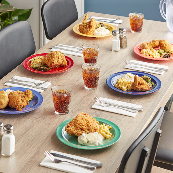 A table with Acopa Foundations melamine plates of food and drinks on it.