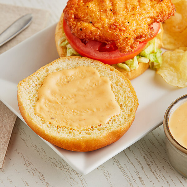 A plate of food with a sandwich and Hidden Valley Buffalo Ranch Dressing.