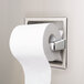 A Bobrick recessed toilet tissue dispenser with an extra roll of toilet paper stored inside.