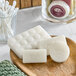 A wooden plate with Noble Eco Novo Natura glycerin soap bars and cotton buds.