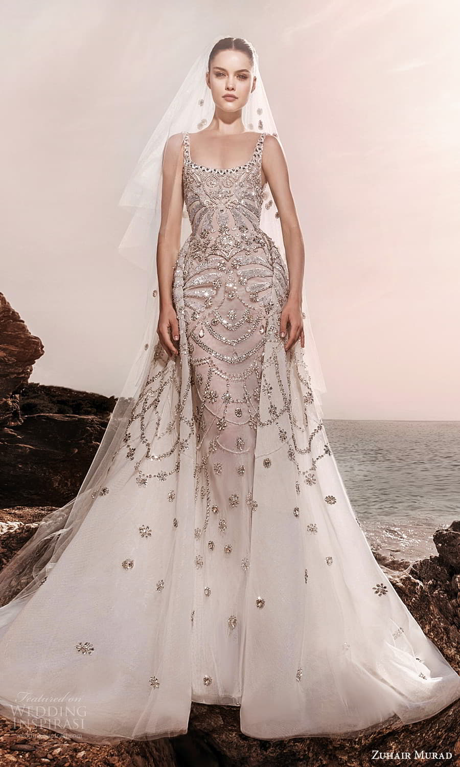 zuhair murad spring 2025 bridal sleeveless thick strap scoop neckline heavily embellished sheath wedding dress a line overskirt chapel train (4) fv