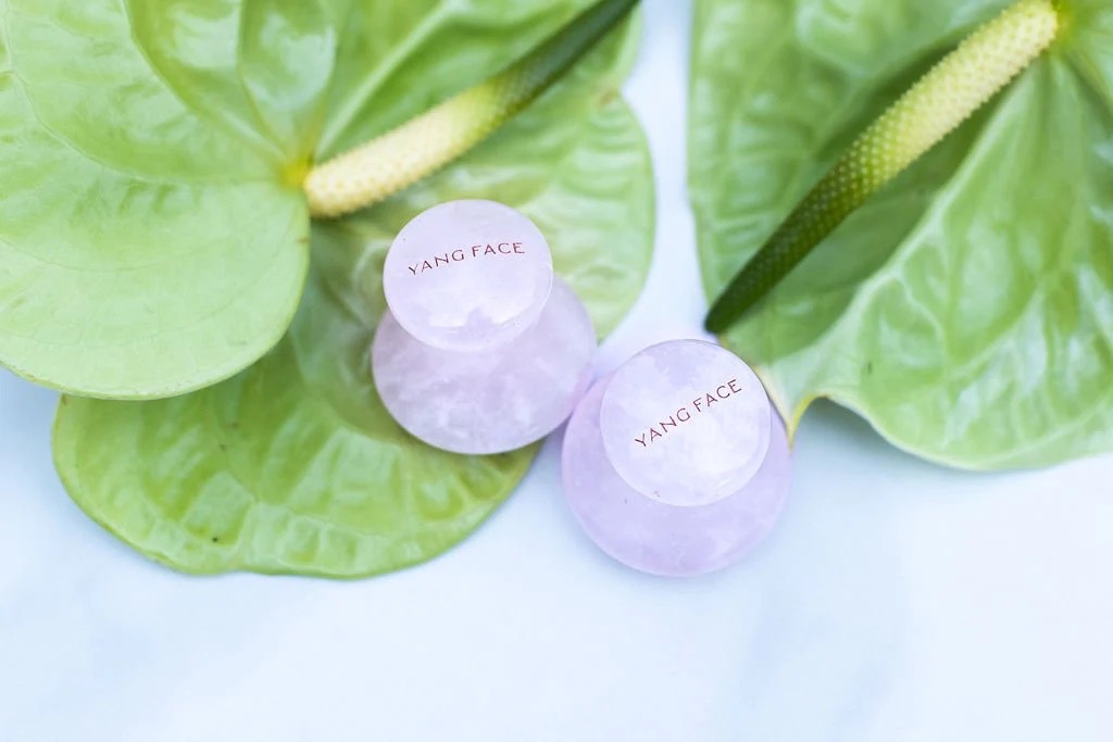 Two rose-quartz facial pounders.