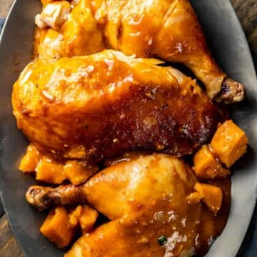 view of Gochujang Chicken in a grey serving bowl on a wood table