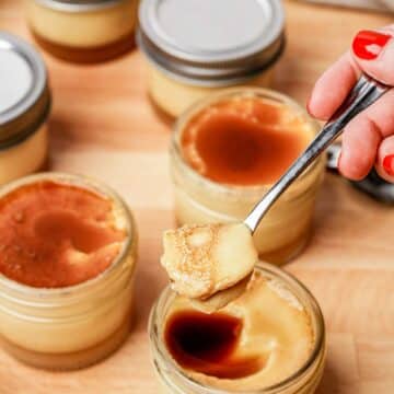 a spoonful of flan over top a jar of flan