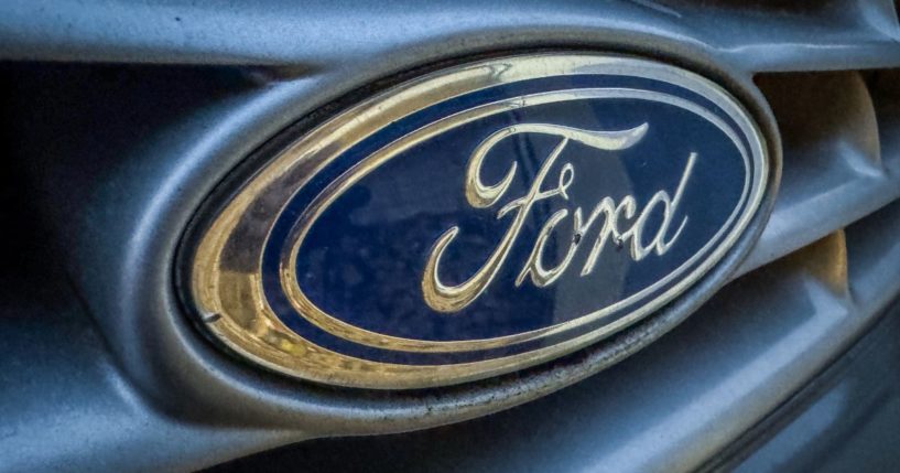 The logo of the Ford Motor Company is displayed on the front grille of a old Ford van in Wells, England, on Nov. 28.