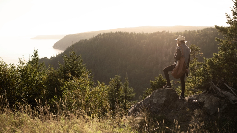 Hiker looking out from atop Fundy Trail Parkway