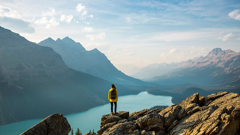 Hiker overlooking Peyto lake and mountains