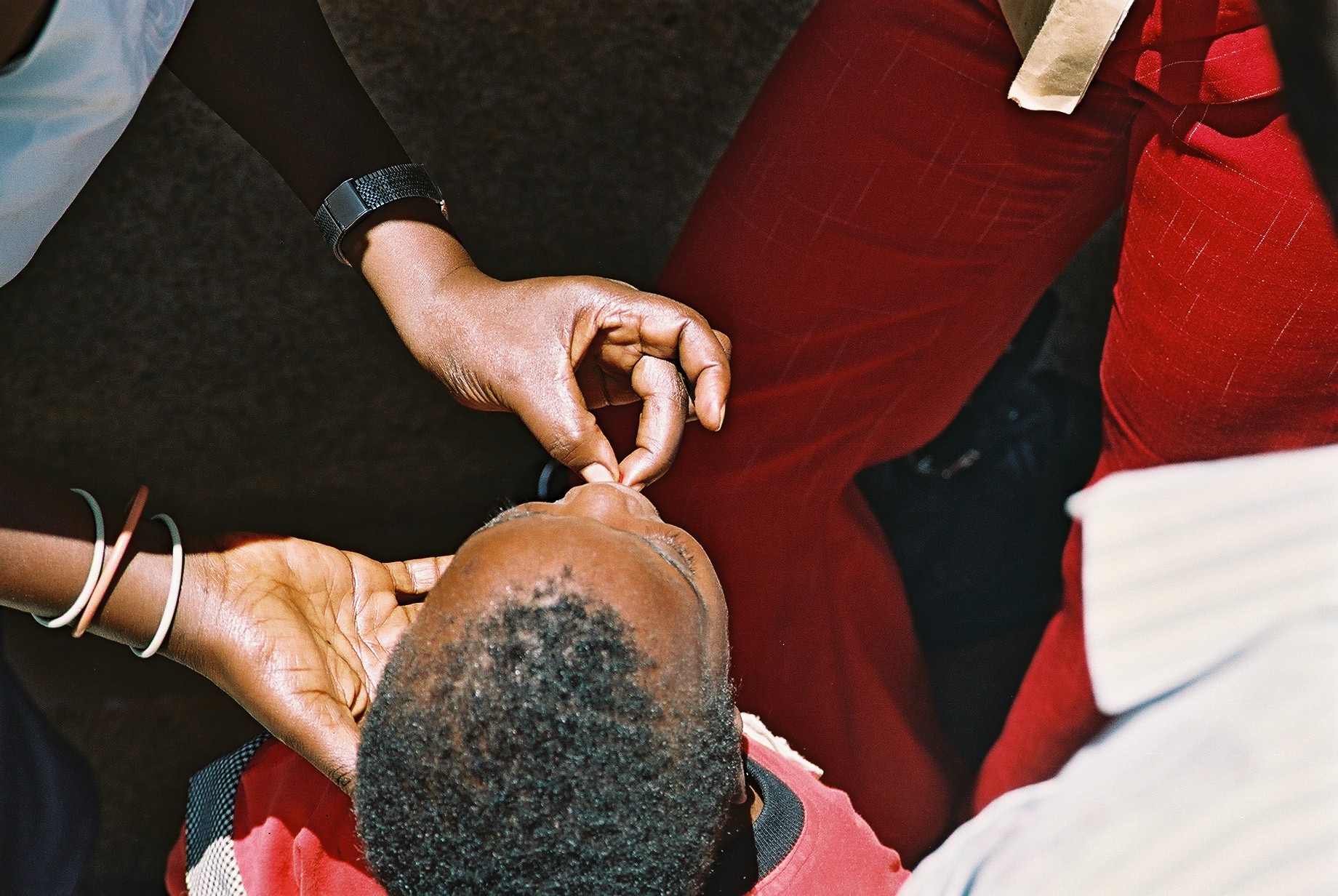 Young child receiving medicine from mother