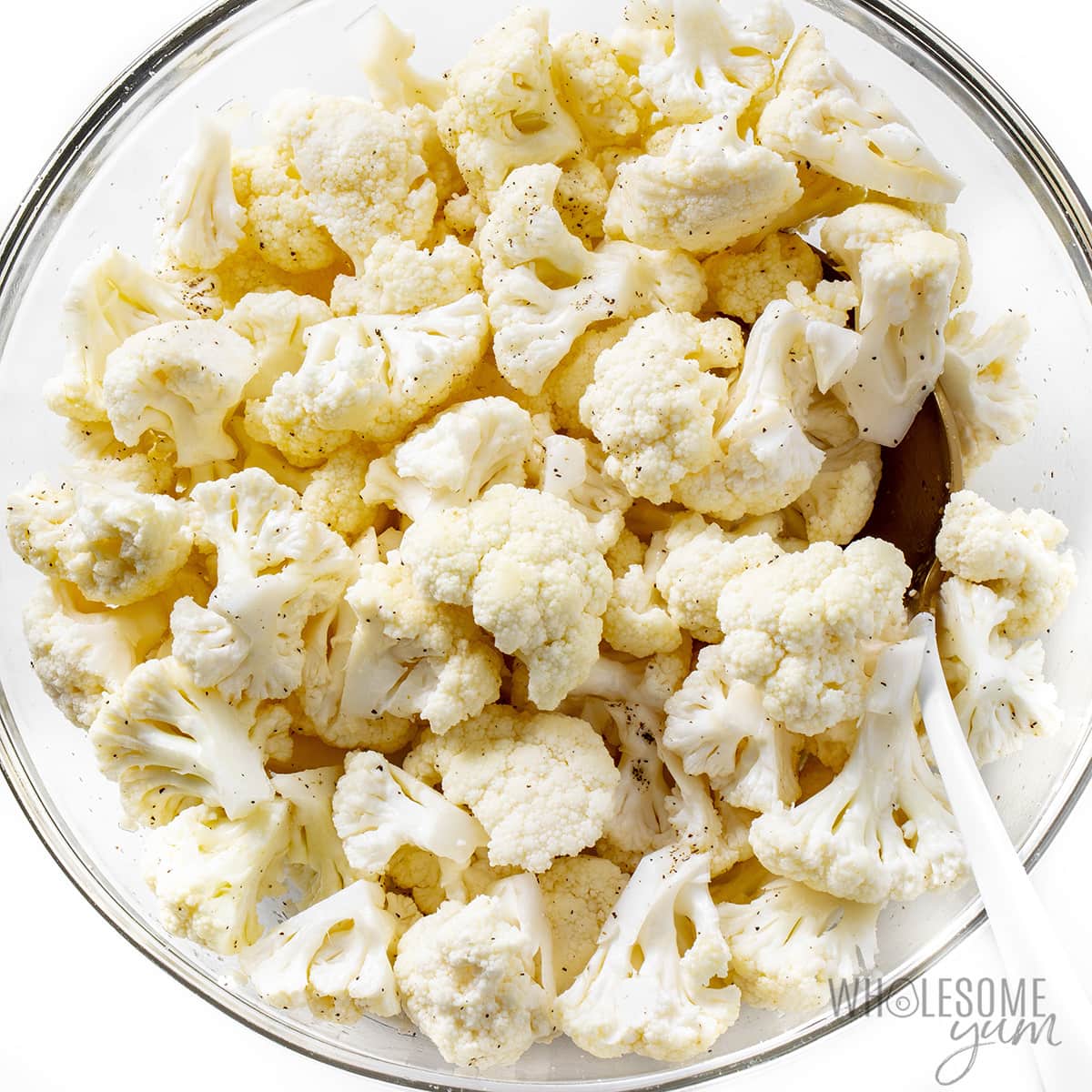 Seasoned cauliflower florets in a bowl.