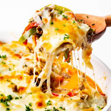 Philly cheesesteak casserole lifted from a baking dish.