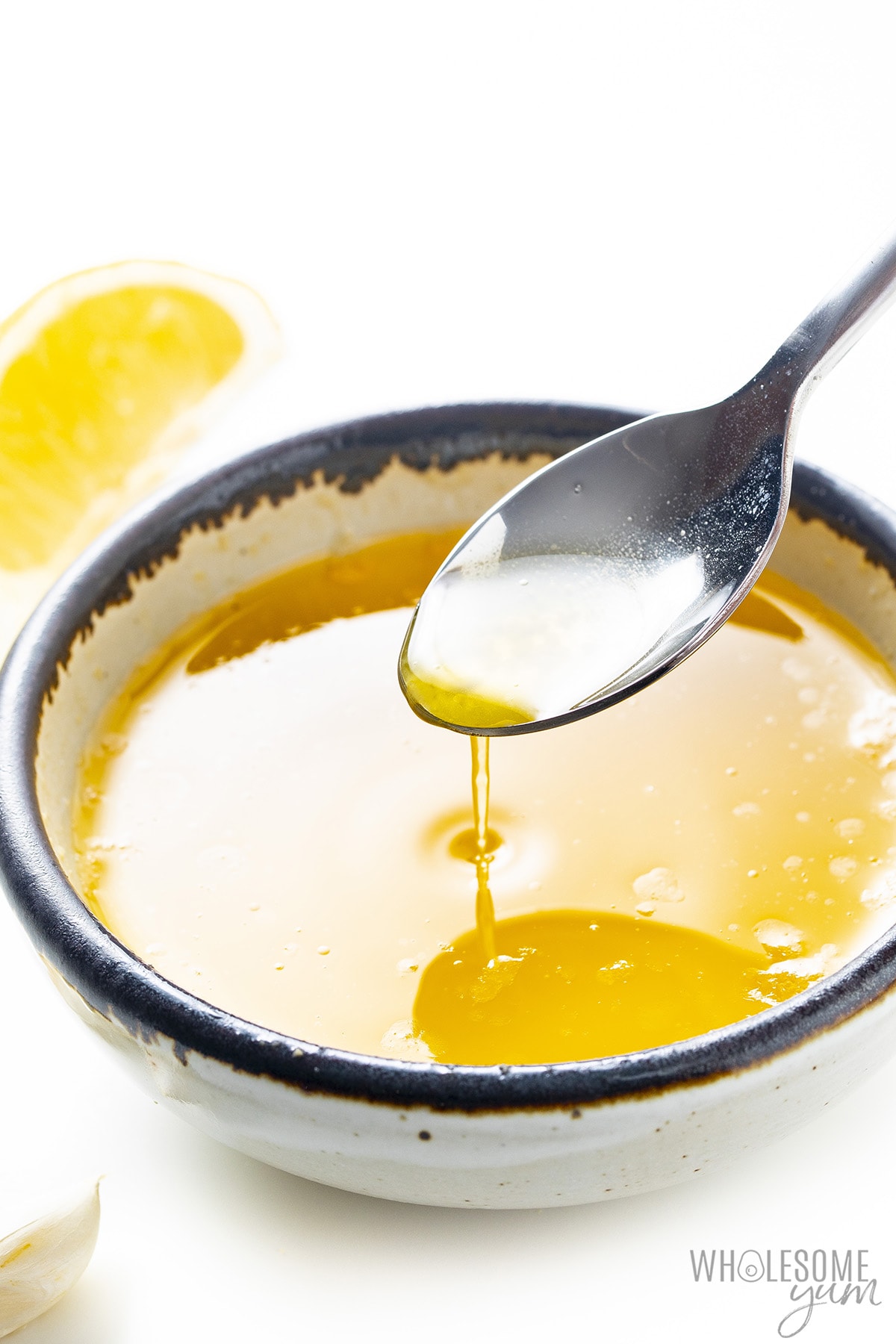 Lemon butter sauce in a bowl with a spoon.