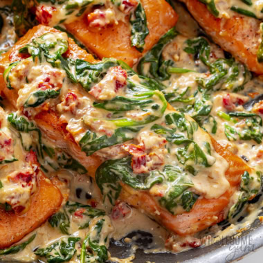 Tuscan salmon in a skillet.