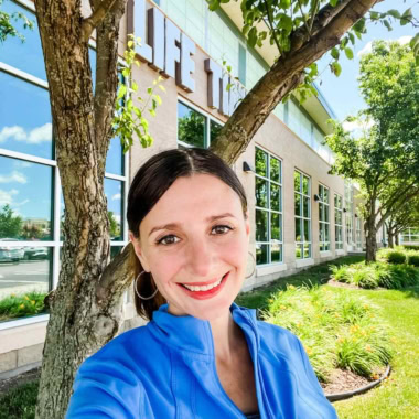 Maya in front of a fitness club.