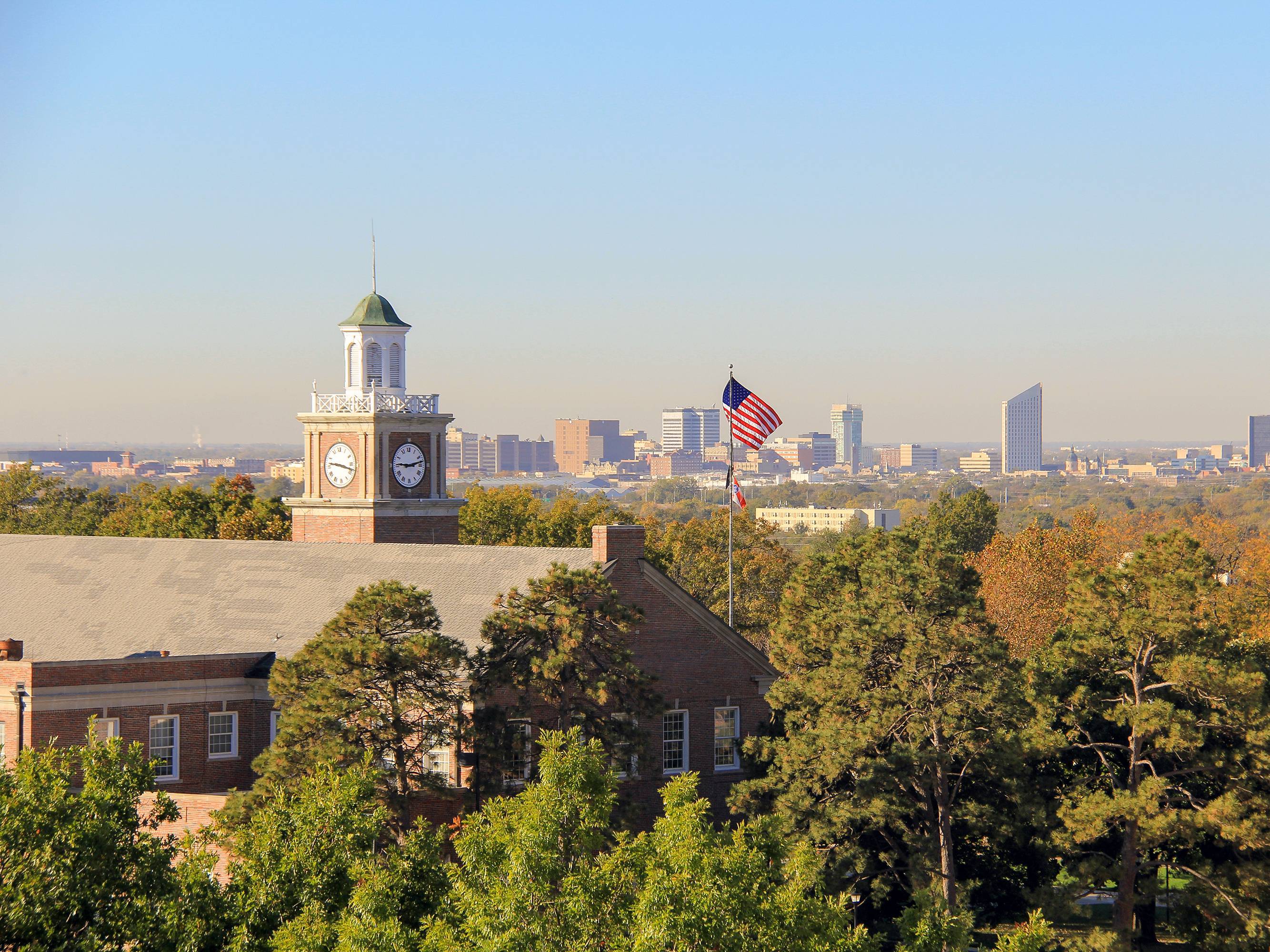 Downtown Wichita skyline visible behind the clock tower of Morrison Hall.