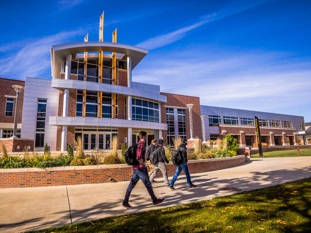 Image of students walking in front of the student center. 