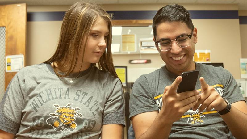 Students looking at cell phone