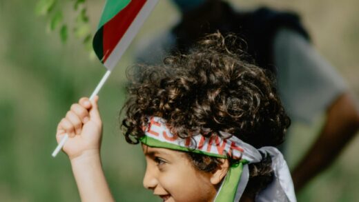 Young boy holding palestinian flag wallpaper