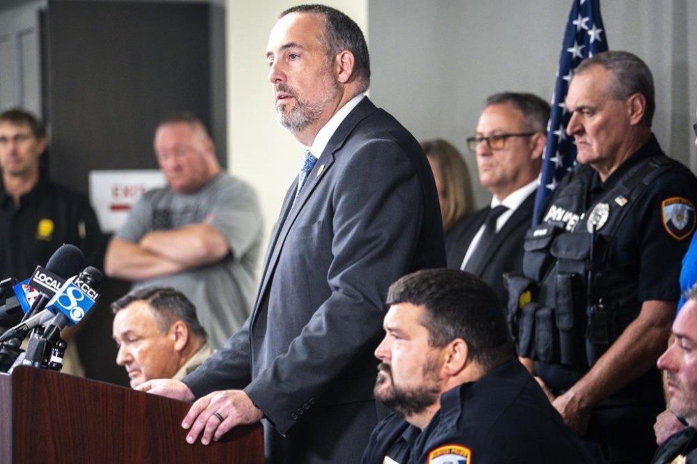 Iowa Department of Public Safety Commissioner Stephan Bayens speaks during a press conference at the Kossuth County Election Center on Thursday, Sept. 14, 2023, in Algona, Iowa. A northern Iowa police officer was shot Wednesday night, prompting a manhunt that ended with an arrest in Minnesota. (Lily Smith/The Des Moines Register via AP)