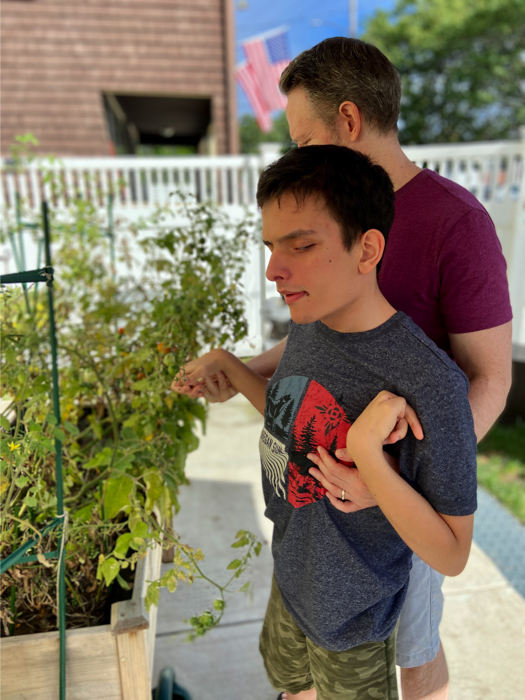 Ivan and his dad picking tomatoes.