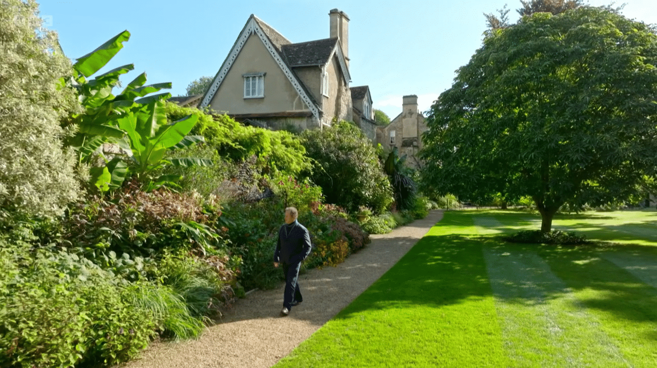 Drone image of Monty Don walking through garden