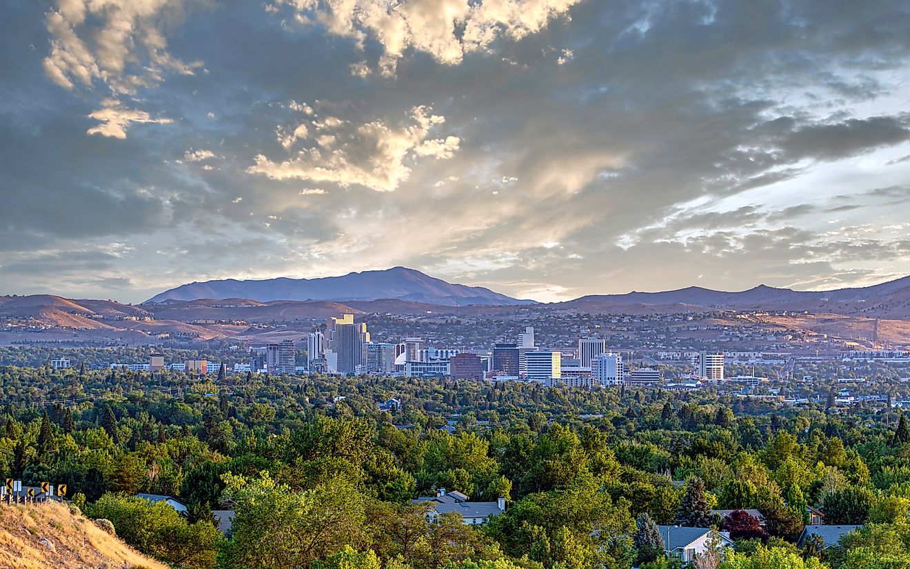 Cityscape of Reno, Nevada, with a dramatic sky overhead, showcasing the city's skyline against striking cloud formations.