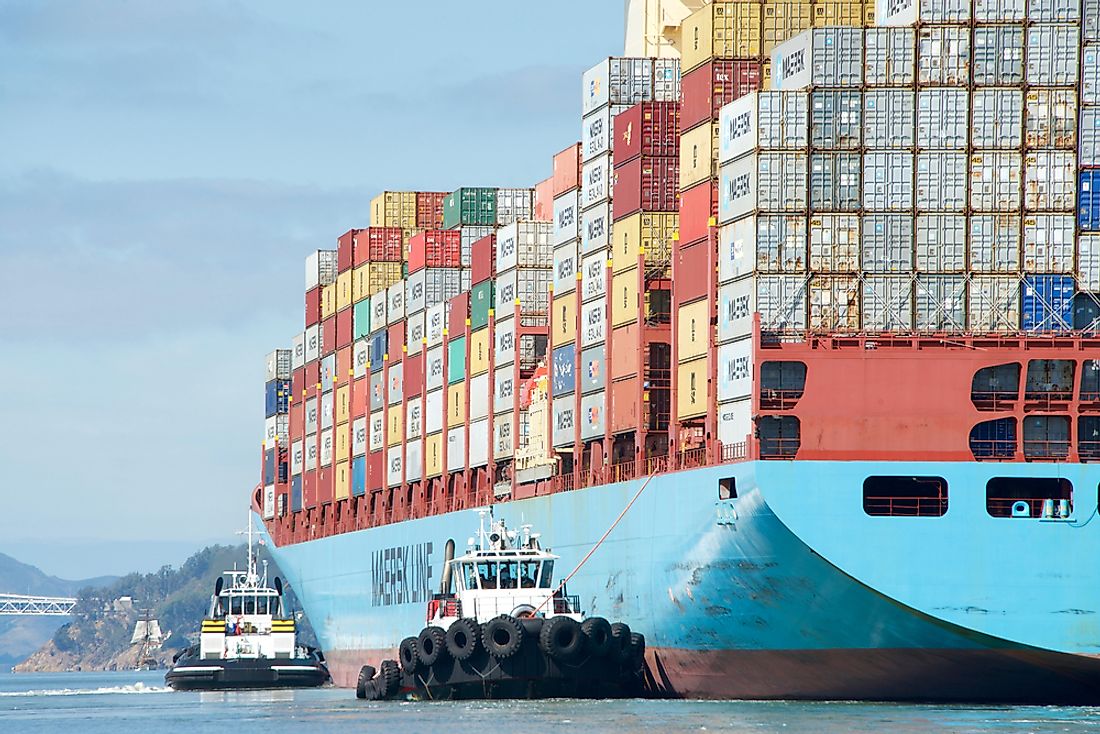 Tugboats assisting cargo ship maneuver into port. Editorial credit: Sheila Fitzgerald / Shutterstock.com