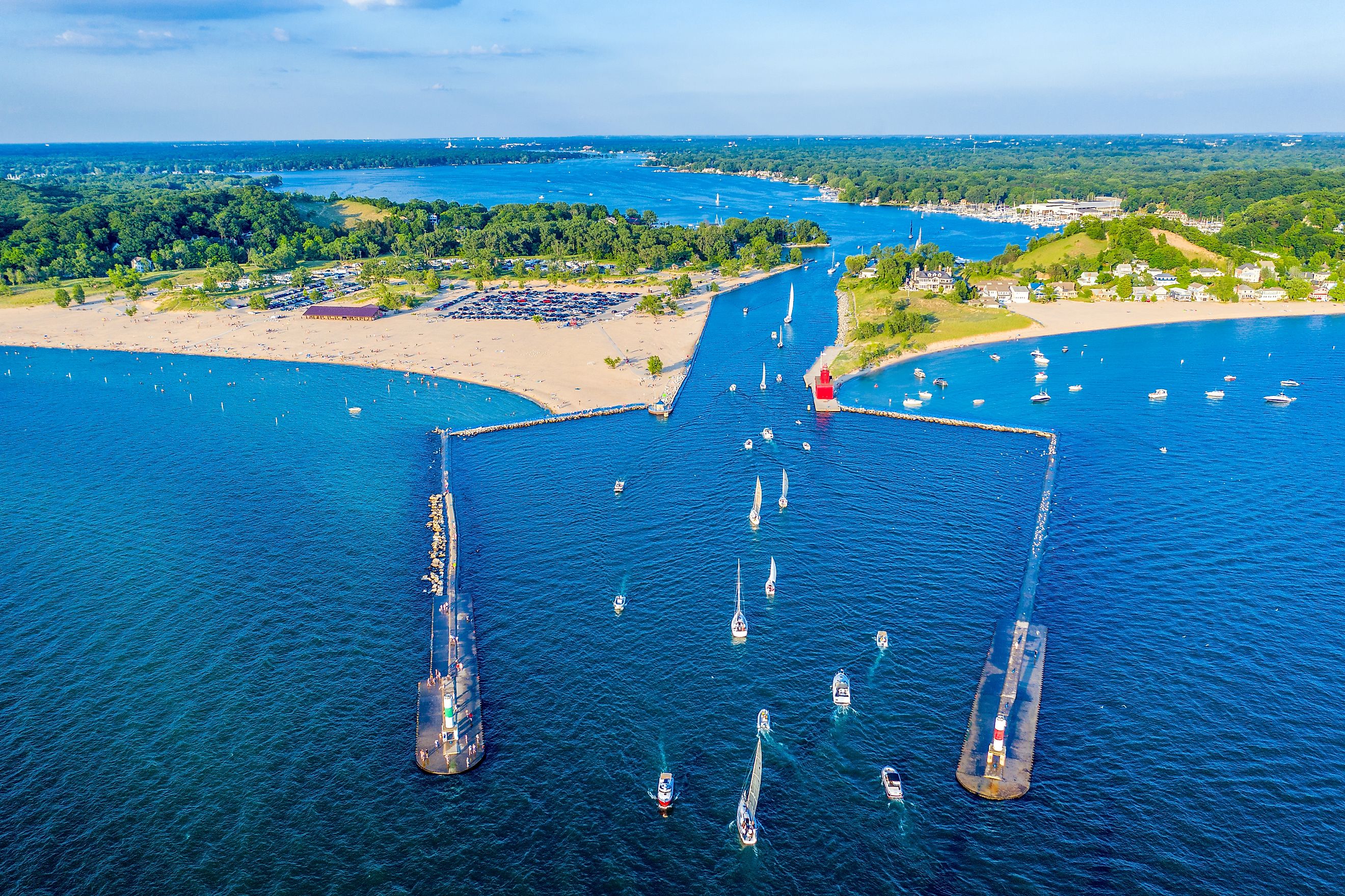 Aerial view of the Holland Harbor Lighthouse at the channel connecting Lake Macatawa with Lake Michigan in Holland State Park, Michigan.