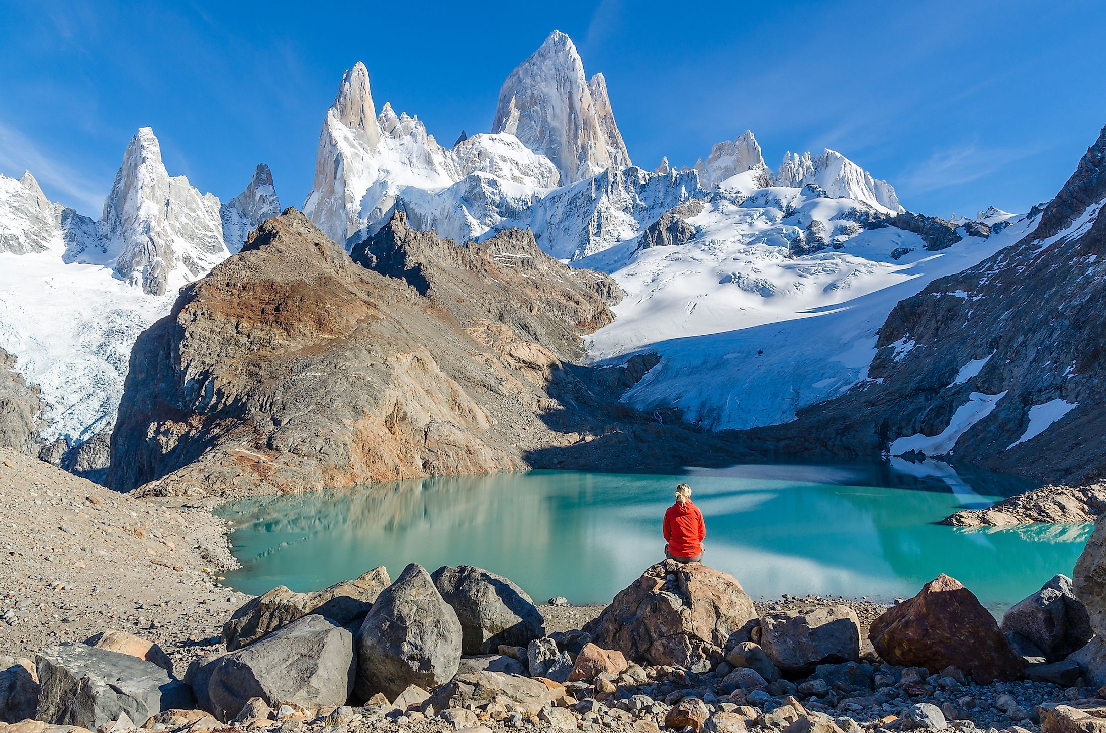 A woman admiring Mount Fitz Roy, part of the Andes Mountains in Argentina.