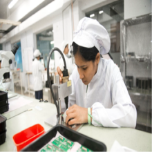 South Asian woman performing circuitry work in a laboratory