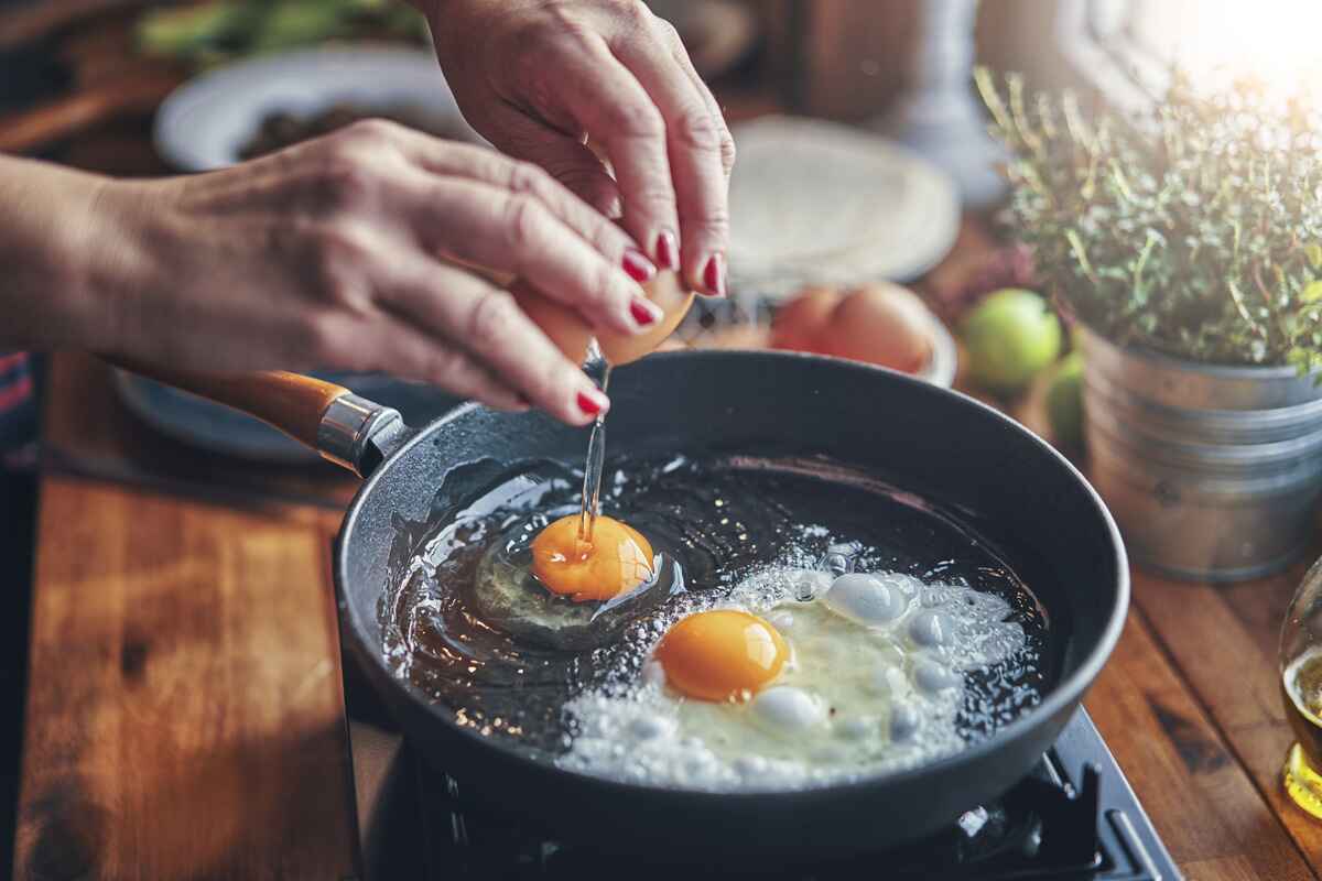 Person frying eggs