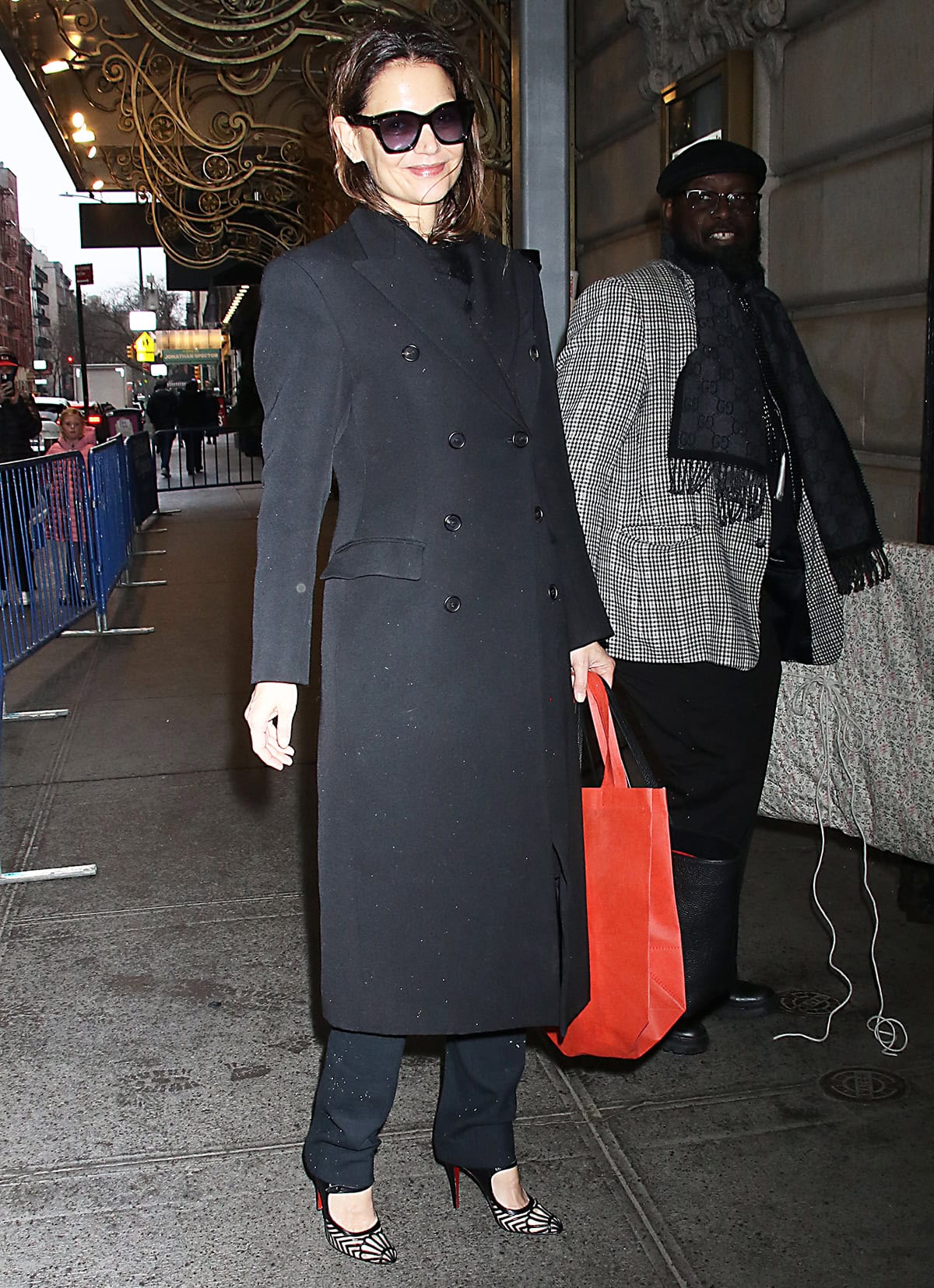 Katie Holmes pairs her Christian Louboutin heels with slim black trousers, a black sweater, and a black double-breasted coat