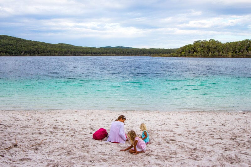 people sitting on the sand with views of Lake Mackenzie 