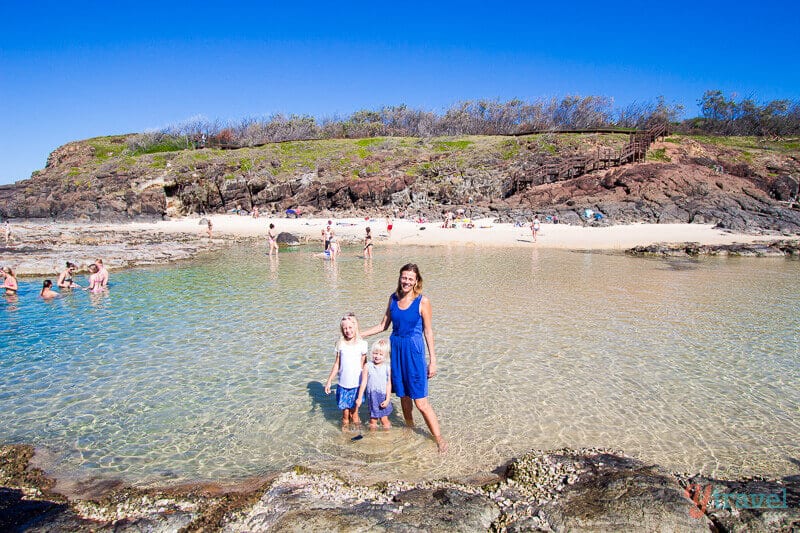 family standing in Champagne Pools 