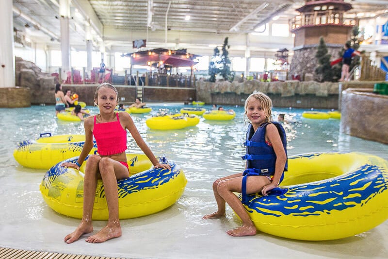 girls sitting on tube at water park