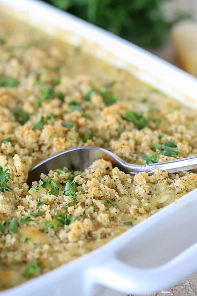 Casserole dish with a spoon getting a generous bite.