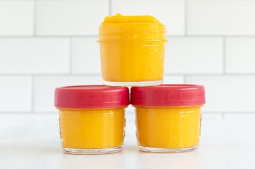 Butternut squash baby food in three glass jars.