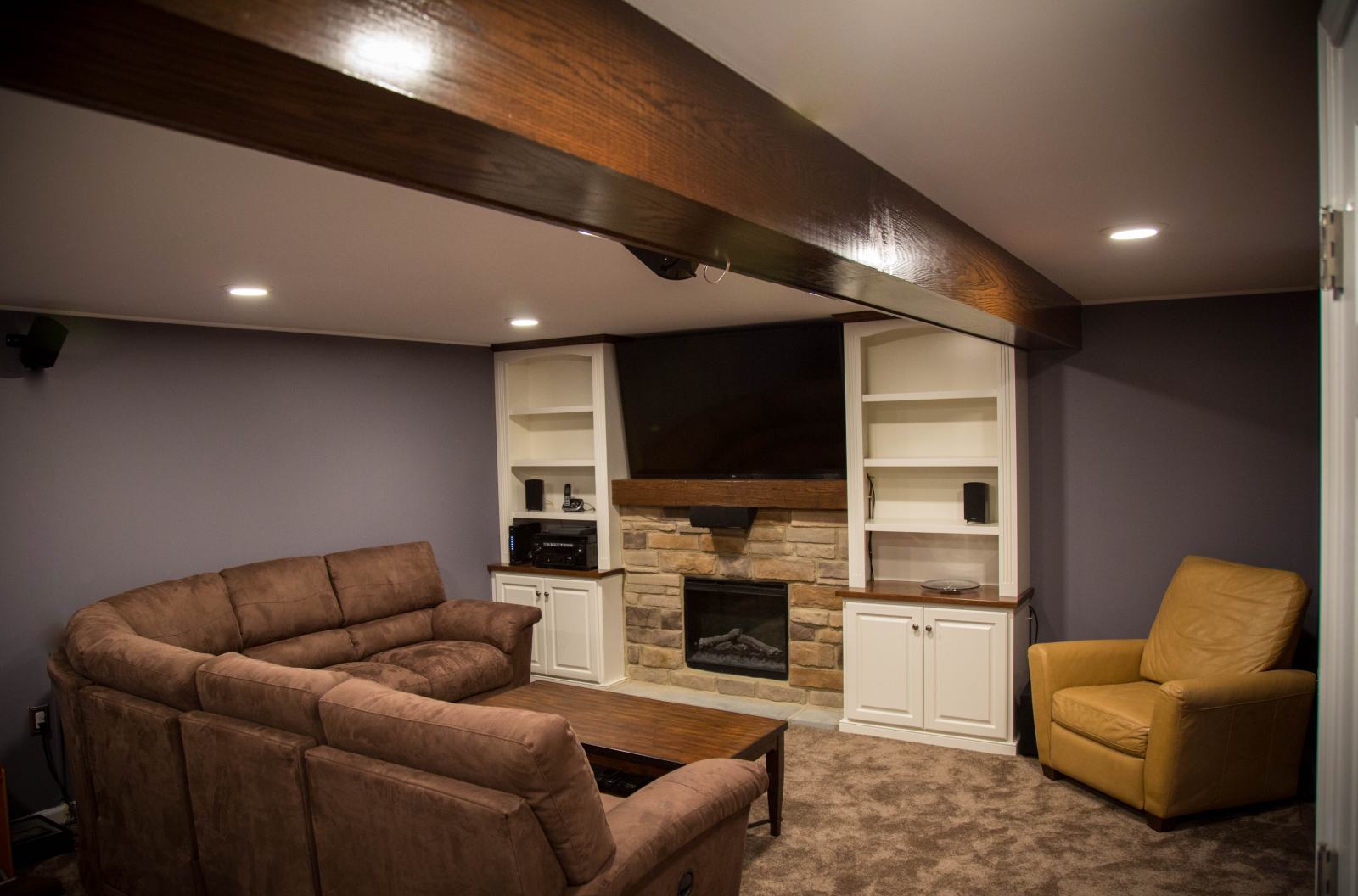 finished basement with fireplace and entertainment center