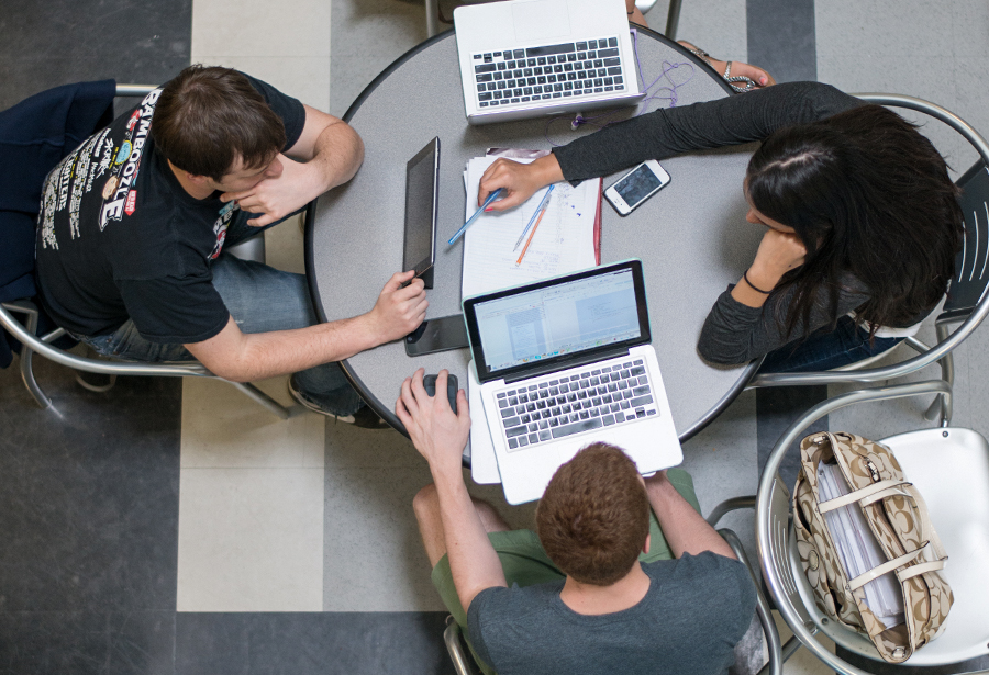 People working on laptops at a table