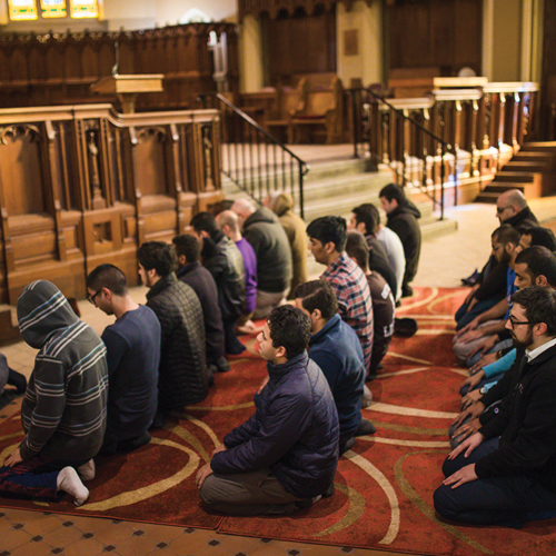 People kneeling in rows