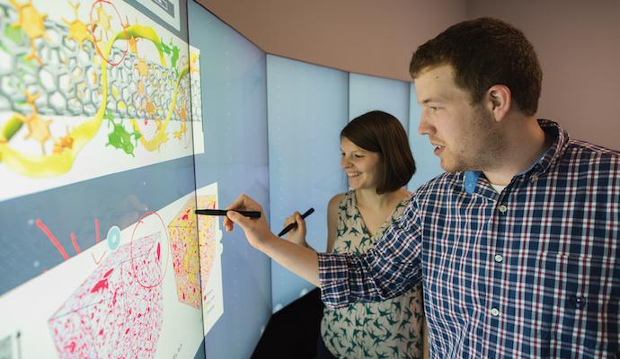 Two people at an interactive whiteboard