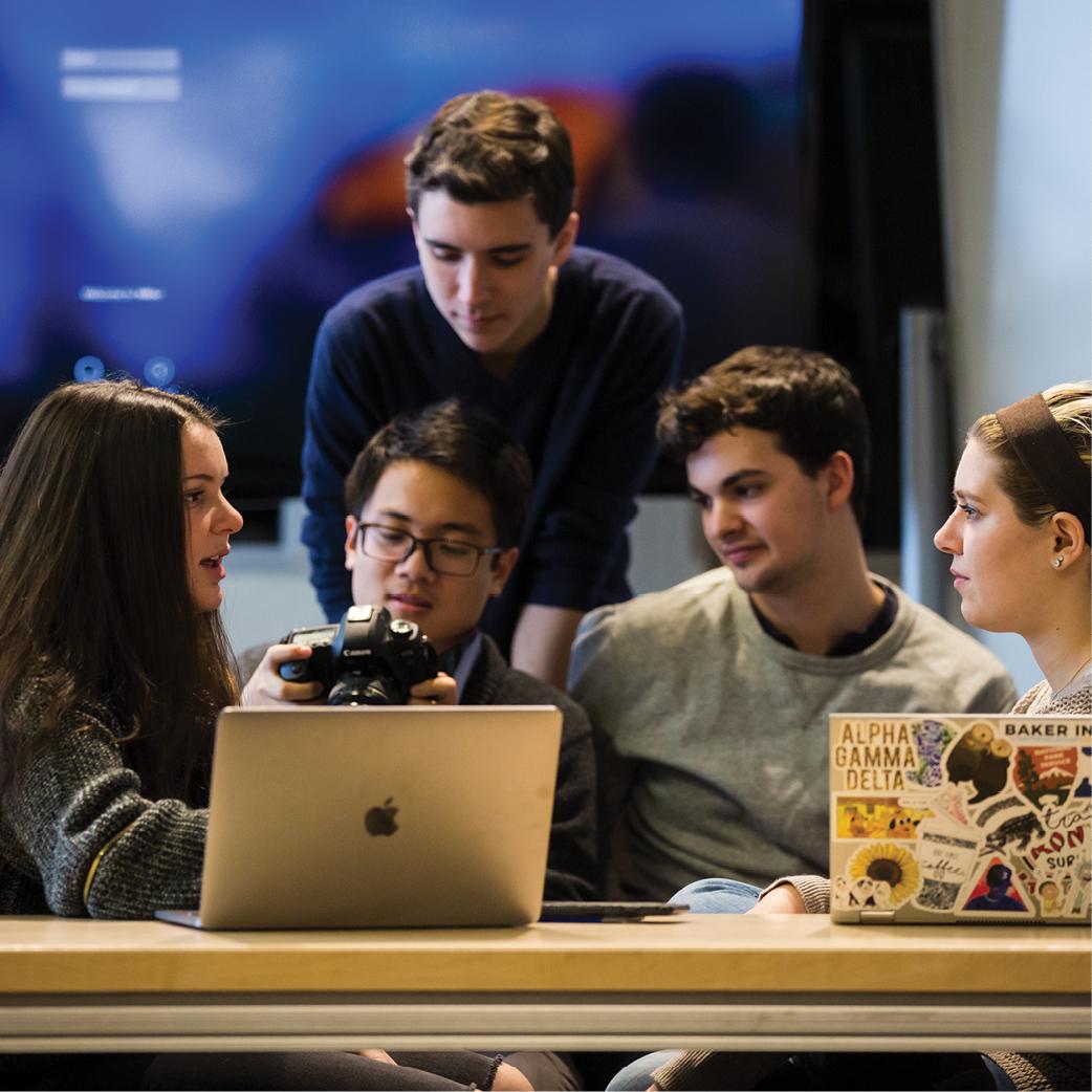 Five students around a laptop