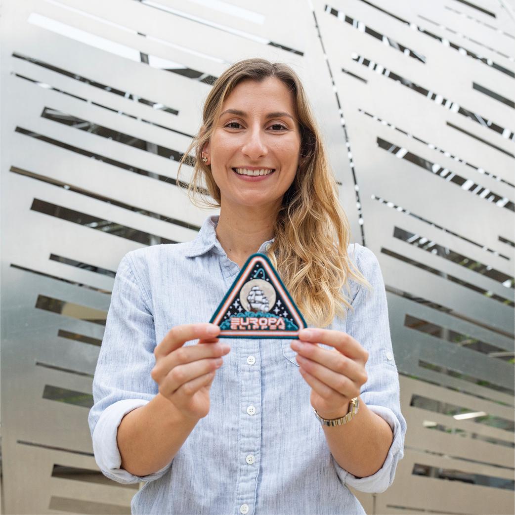 Pam Fusek holding a NASA patch