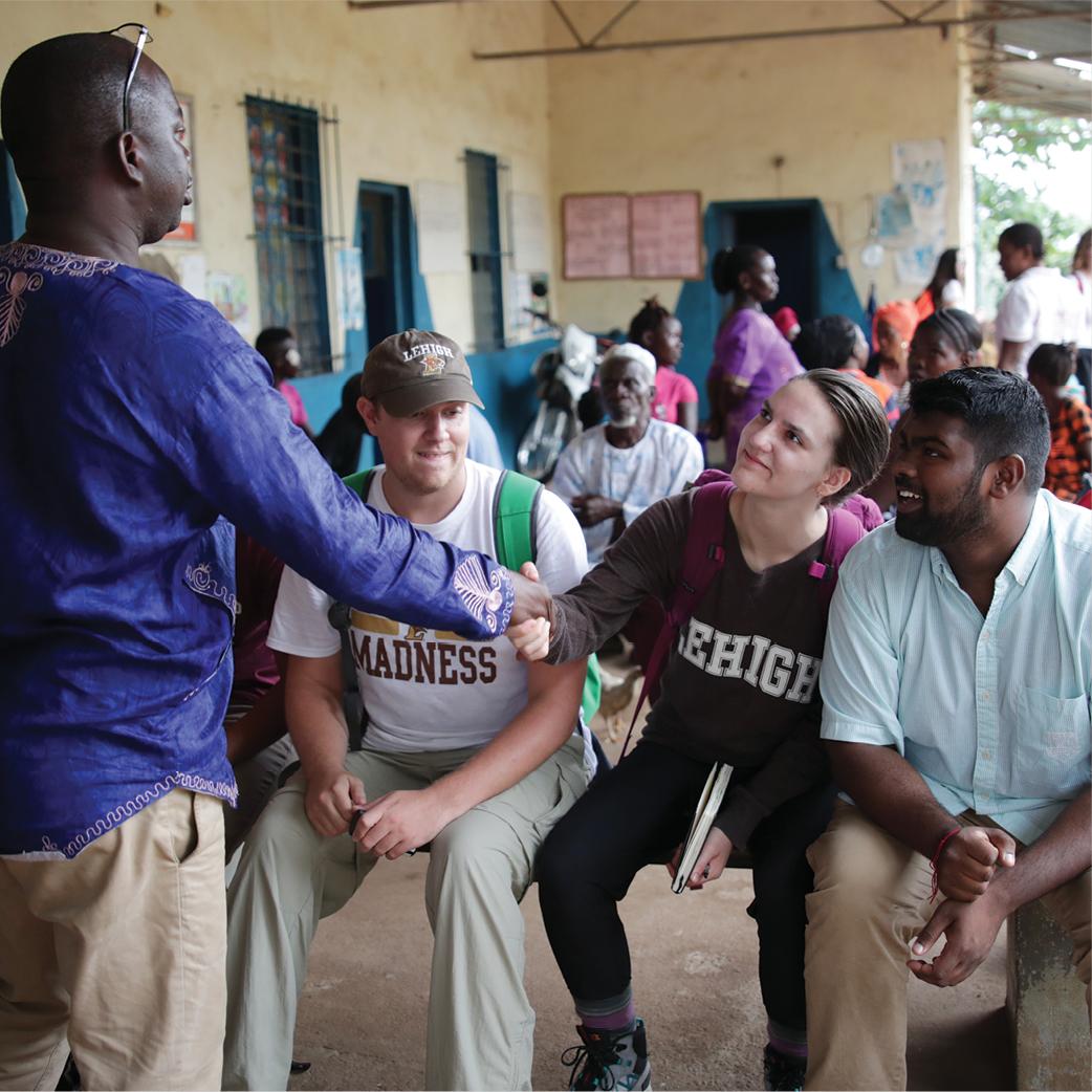 Students talking to a man in Sierra Leone